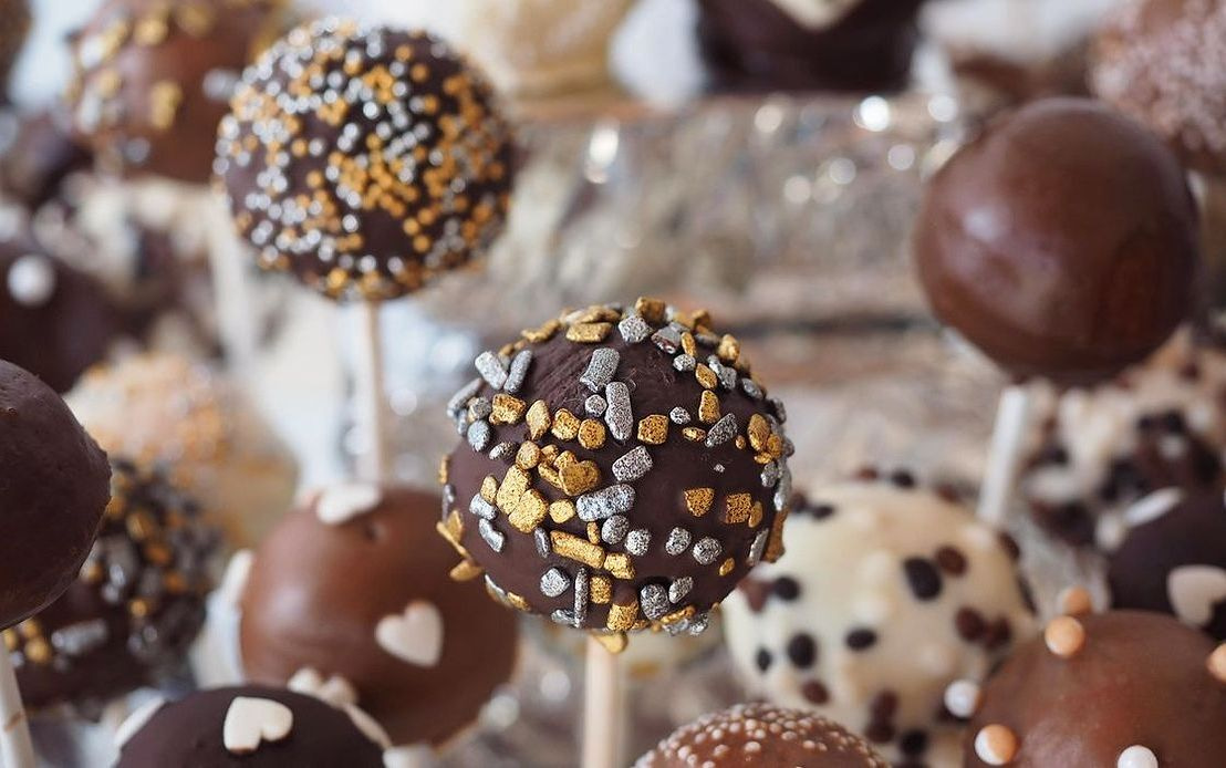 A salted caramel sweet, golden and glossy, on a branded wrapper